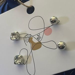 Silver tone and faux crystal stud earrings.